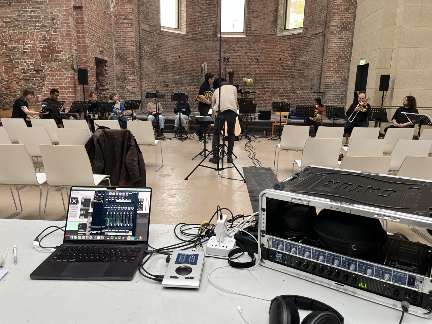 Recording and playback station in a brick church during a brass ensemble rehearsal